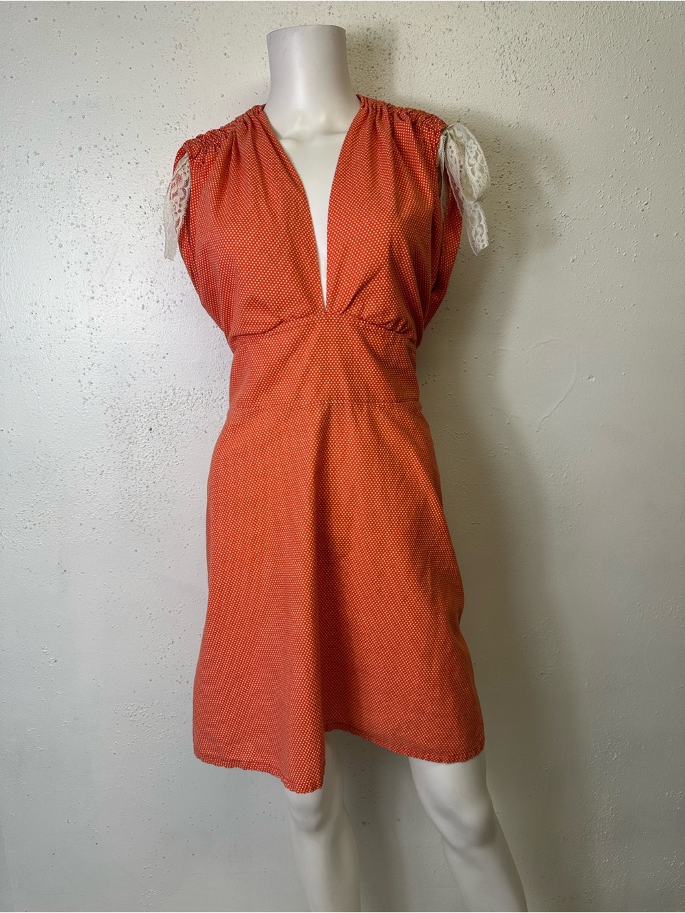 Brazen Judy vintage orange polka-dot mini dress features a plunging V-neckline L